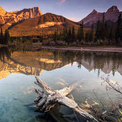 Scenic view of lake by mountains against sky