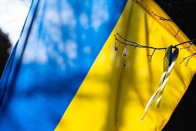 Ribbon with colors of ukraine during a peaceful demonstration against war, ukrainian flag background