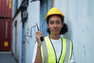 Portrait of young man working in factory