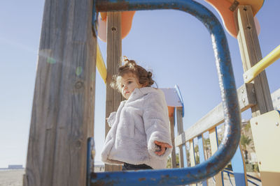 Portrait of boy looking through window