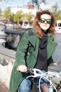 Portrait of smiling man sitting on bicycle