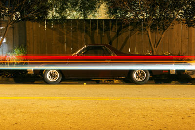 Vintage classic american muscle pick up truck car and light trails  in venice beach, california 