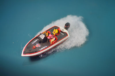 High angle view of toy boat against blue background