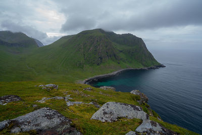 Scenic view of sea and mountains against sky