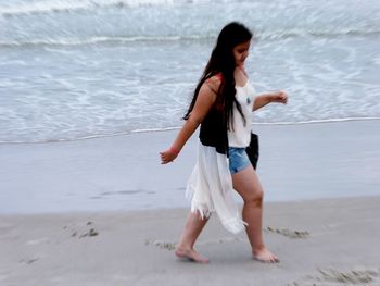 Full length of woman standing on beach