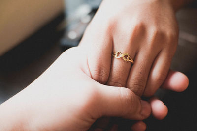 Close-up of couple holding hands