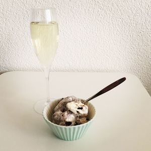 High angle view of ice cream by champagne on table