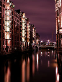 Illuminated buildings with waterfront at night