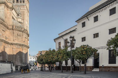 Buildings in city against clear blue sky