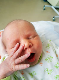 Close-up of baby boy on bed