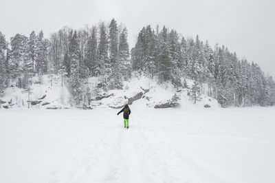 Full length of man skiing on snow covered landscape