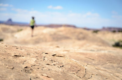 Man walking on land against sky