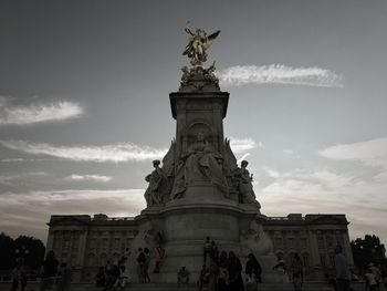 Low angle view of statue against cloudy sky