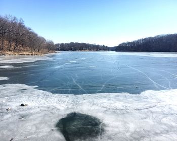Scenic view of frozen lake against clear sky