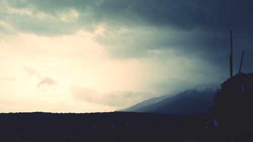 Scenic view of silhouette mountains against sky at sunset