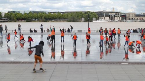 Group of people walking in front of buildings