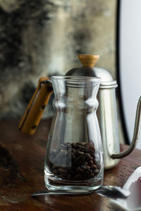 Close-up of coffee beans in glass on table