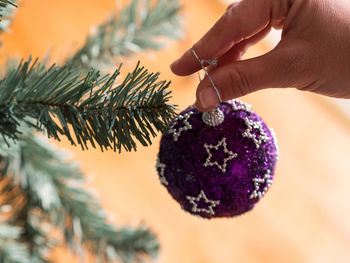 Close-up of hand holding christmas tree