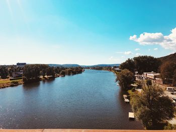 Scenic view of river against sky in city