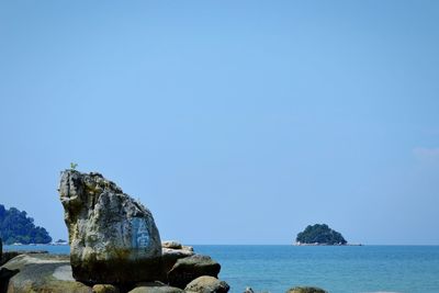 Scenic view of sea against clear blue sky