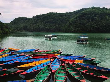 Boats sailing in river against sky