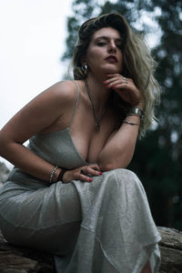 Portrait of beautiful young woman sitting outdoors