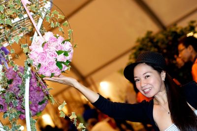 Portrait of a smiling young woman with flowers