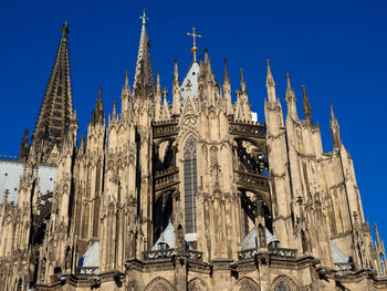 Low angle view of cologne cathedral against clear blue sky