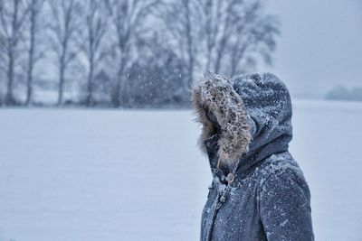 Rear view of person on snow covered field