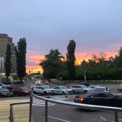 Traffic on road at sunset