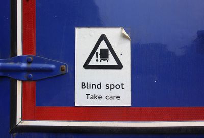 Close-up of warning sign on road