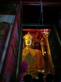 Low angle view of buddha statue at night