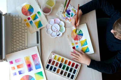 High angle view of woman holding colorful painting