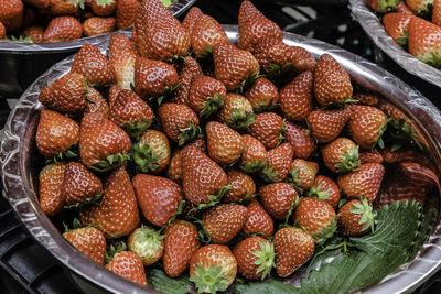 Close-up of strawberries in containers for sale at market