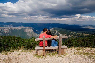 Lifeguard hut sitting on landscape against mountains