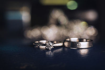 Close-up of wedding rings on table