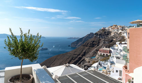 High angle view of townscape by sea against sky