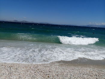 Scenic view of beach against blue sky