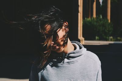 Portrait of beautiful young woman standing outdoors