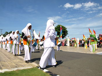 Group of people at street market against sky