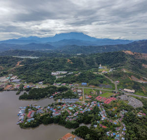 Aerial view of buildings and mountains against sky