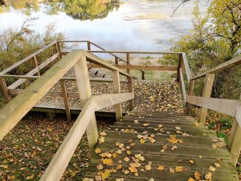 Steps amidst trees against sky during autumn