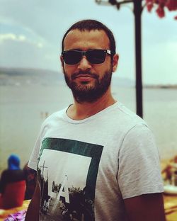 Portrait of young man wearing sunglasses standing outdoors