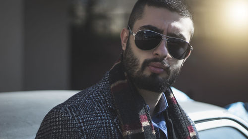 Portrait of bearded young man wearing sunglasses in city