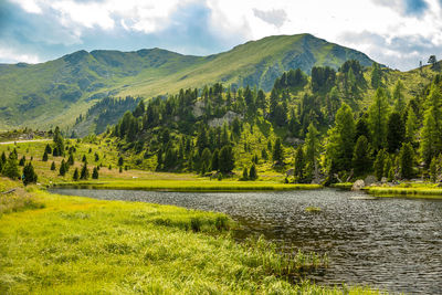 Scenic view of lake and mountains against sky