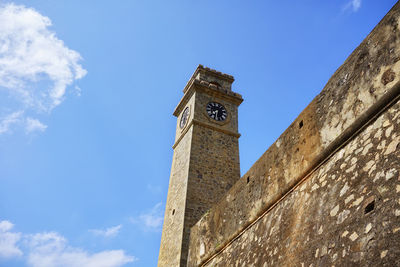 Low angle view of clock tower against sky