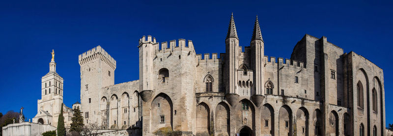 Low angle view of buildings against blue sky