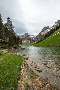 Scenic view of lake and mountains against sky