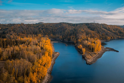 Scenic view of river against sky during autumn