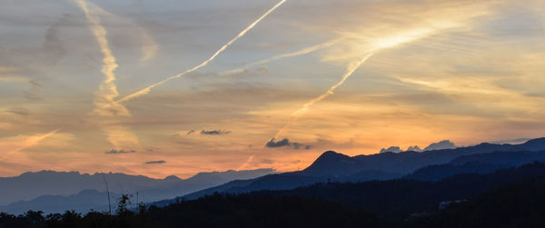 Scenic view of silhouette mountains against sky during sunset